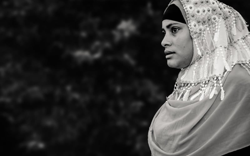 Black and white image of woman wearing a hijab
